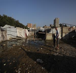 نازحون يقيمون في خيام مهترئة في مخيم النصيرات يواجهون كارثة بيئية، حيث تتراكم النفايات وتنتشر المياه العادمة حول أماكن إقامتهم وسط مخاوف من تفشي الأمراض